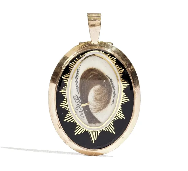 An oval pendant mourning locket, second quarter of the 19th century, glazed to the front with a feathered hairwork spray within a gilt highlighted bla