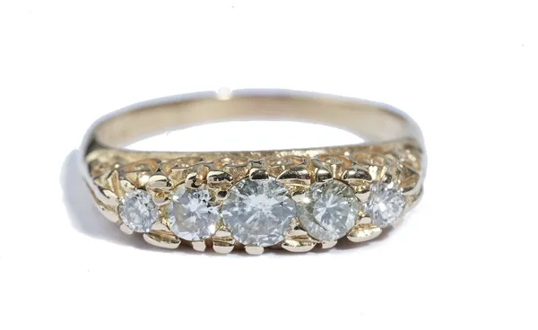 An 18ct gold and diamond five stone ring, set with a row of circular cut diamonds, graduating in size to the centre stone, the mount decorated with sc