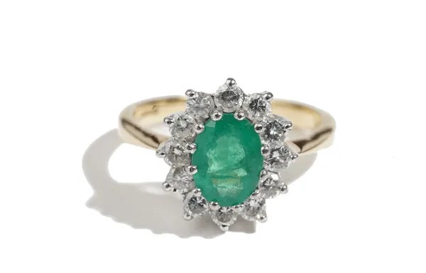 A gold, emerald and diamond oval cluster ring, claw set with the oval cut emerald in a surround of circular cut diamonds, ring size O, gross weight 5.