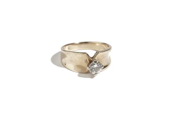 A gold and diamond single stone ring, claw set with a circular cut diamond, detailed 14 K, ring size N.