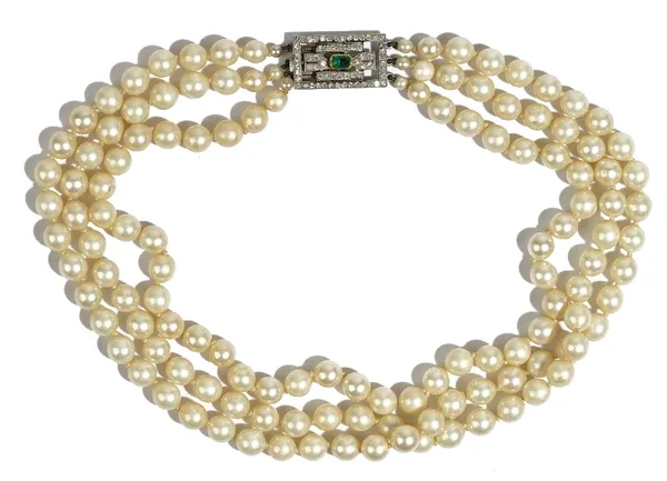 A three row necklace of imitation pearls, on a diamond and emerald rectangular clasp, pierced in a geometric design, mounted with the rectangular cut