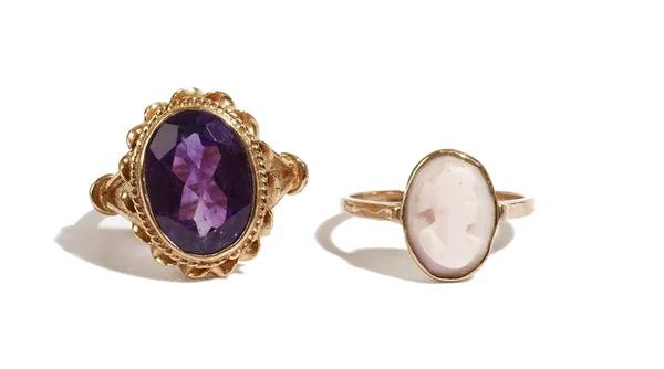 A 9ct gold ring, collet set with an oval cut amethyst within a ribbon twist surround, London 1973, ring size N and a gold and pink shell cameo ring, r