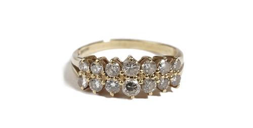 An 18ct gold and diamond ring, claw set with two rows of seven circular cut diamonds graduating in size to the centre stone, ring size P, gross weight