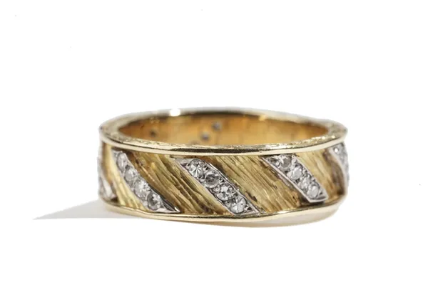 A gold and diamond set band ring, mounted with rows of four circular cut diamonds in a slanting design, otherwise having a bark textured finish and wi