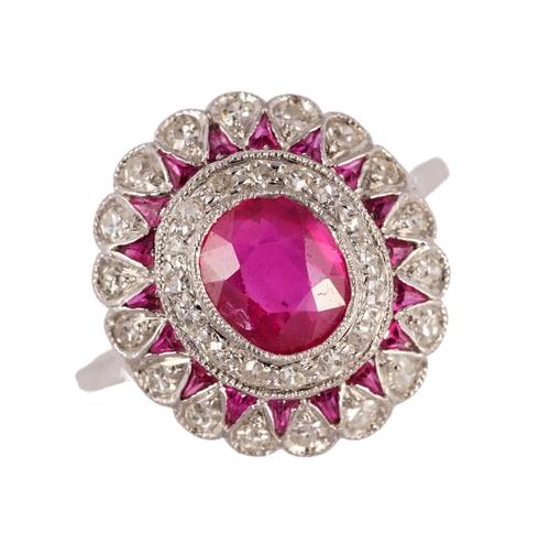 A ruby and diamond ring, mounted with the principal cushion shaped ruby to the centre, in a surround of cushion shaped diamonds and with an outer bord