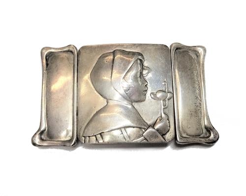 A lady's silver Art Nouveau waist belt buckle, the centre cast as the portrait of a girl holding a flower, between shaped sides, length 8cm, London 19