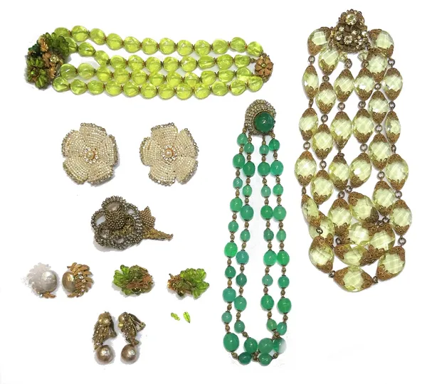 A group of Miriam Haskell costume jewellery, comprising; three glass bead necklaces, a brooch designed as a flower and four pairs of earclips, in a va