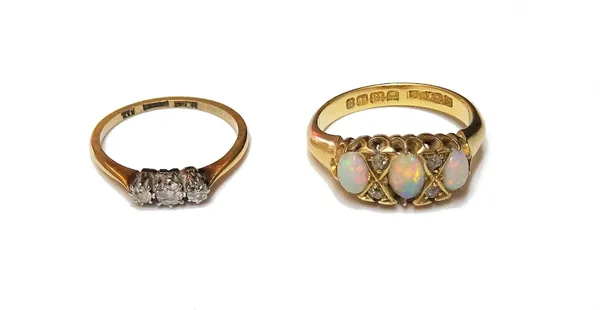 An 18ct gold, opal and diamond ring, mounted with three oval opals and with two pairs of cushion shaped diamonds at intervals, Birmingham 1900, ring s