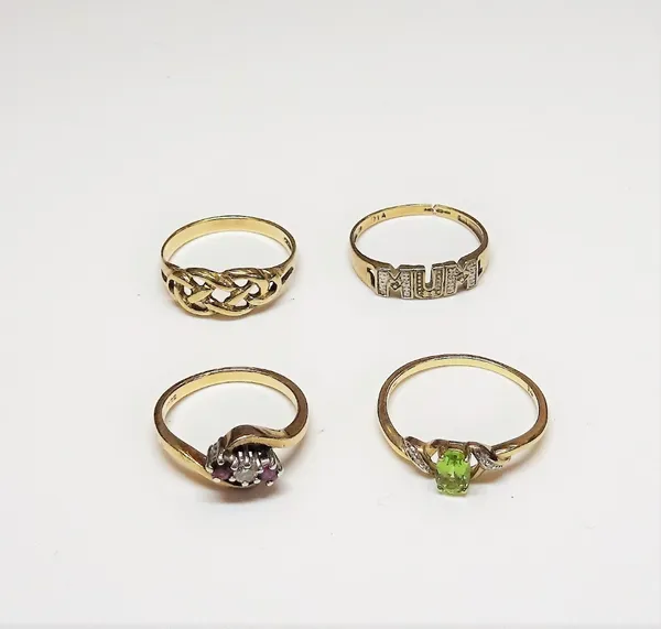 A 9ct gold, ruby and diamond three stone ring, in a crossover design, a 9ct gold, peridot and diamond ring, in a twist design, a 9ct gold ring detaile