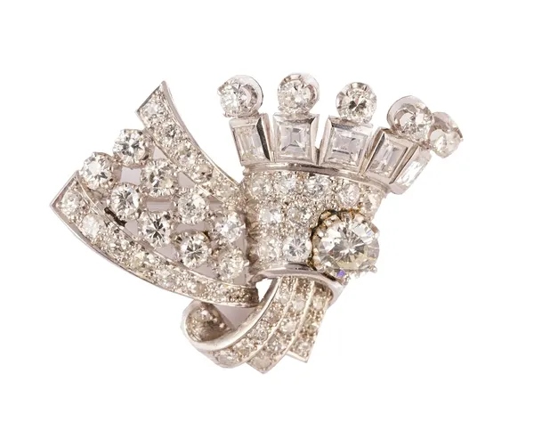 A diamond brooch, in a stylized coronet and spray Art Deco design, mounted with circular cut and emerald cut diamonds, circa 1925, gross weight 12 gms