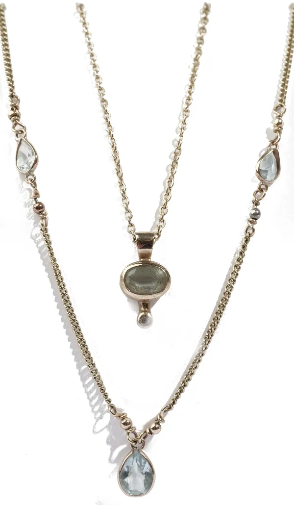 A gold and aquamarine necklace, mounted with the principal pear shaped aquamarine to the drop and with two smaller pear shaped aquamarines, on a curb