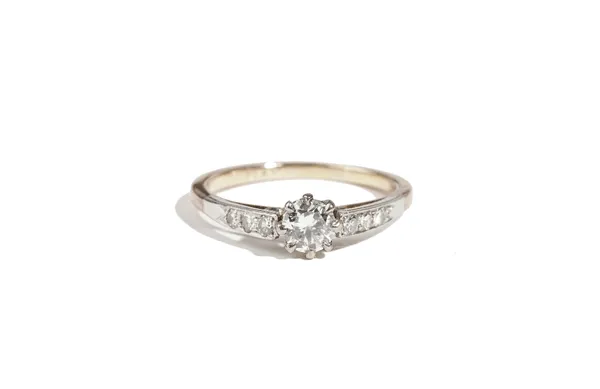 A gold and platinum, diamond ring, claw set with the principal circular cut diamond to the centre, between diamond three stone shoulders, detailed PLA