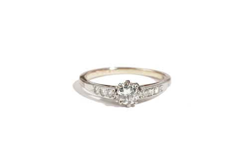 A gold and platinum, diamond ring, claw set with the principal circular cut diamond to the centre, between diamond three stone shoulders, detailed PLA
