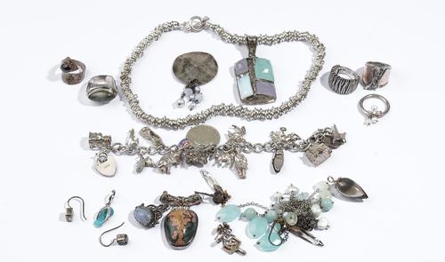 A group of jewellery, comprising; a silver necklace in a circular link design, on a T bar and loop shaped clasp, a charm bracelet, on a heart shaped p