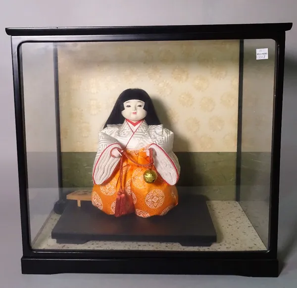 Two modern Japanese dolls in display cabinets, the largest 50cm wide x 45cm high.