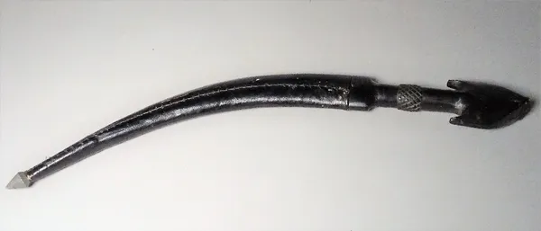 A Middle Eastern horn handled knife, late 19th/ early 20th century with engraved curved steel blade, 23cm, and leather bound scabbard.