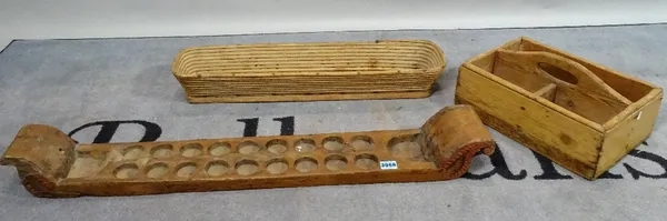 Collectables, comprising; a fruitwood twin handled eighteen division egg tray, 95cm wide, a pine three division tray and a wide planter, 66cm wide. (3