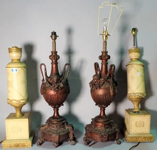 A pair of early 20th century cast metal table lamps, of urn form, 71cm high, and a pair of Regency style painted metal lamps, 57cm high. (a.f.) (2 pai