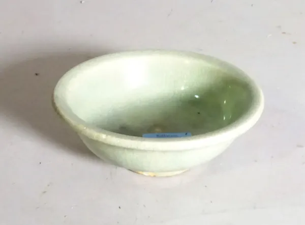 A small Chinese Lonquan celadon glazed bowl, Ming dynasty, 16th/17th century, shallow form, covered in a pale green glaze, 12.75cm diameter.