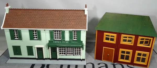 Two modern dolls houses, the larger one modelled as a shop, 94cm wide x 68cm high. (2)