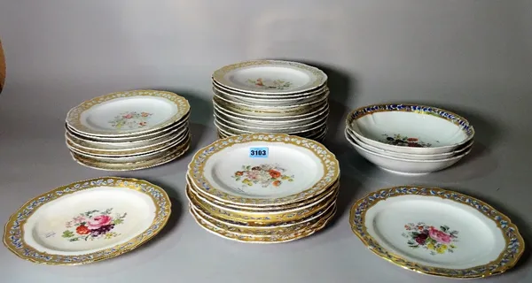 A 19th Century Berlin part dinner service decorated with floral and gilt.