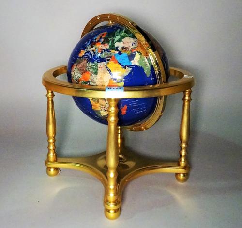 A modern table top terrestrial globe formed from specimen stone with gilt brass base, 34cm wide x 38cm high.