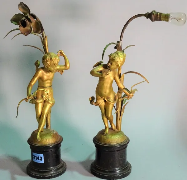 A pair of early 20th century gilt metal table lamps, formed as cherubs, 39cm high. (2)