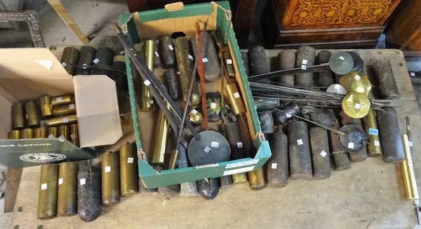 A large quantity of assorted 17th century and later longcase and wall clock weights and pendulums.