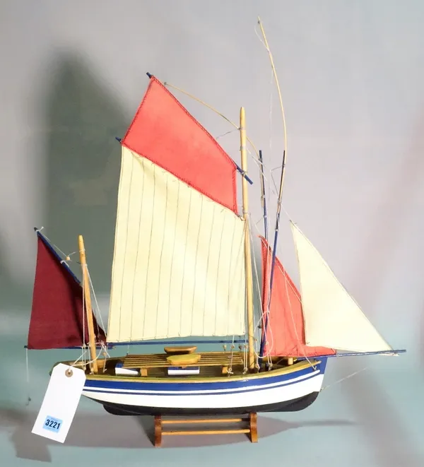 A modern wooden model of a sailing boat, 53cm wide x 69cm high.