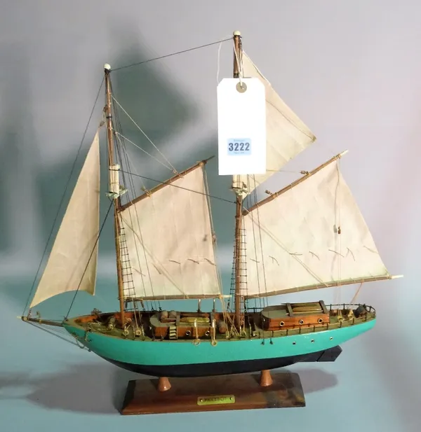 A modern wooden model of a sailing boat, 51cm wide x 51cm high.