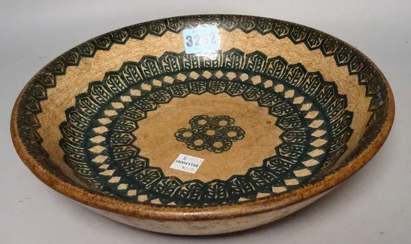 A Middle Eastern pottery bowl decorated with bands of green, 24.5cm.