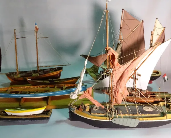 A group of eight modern wooden models of boats and sailing ships, the largest 60cm wide x 56cm high. (8)