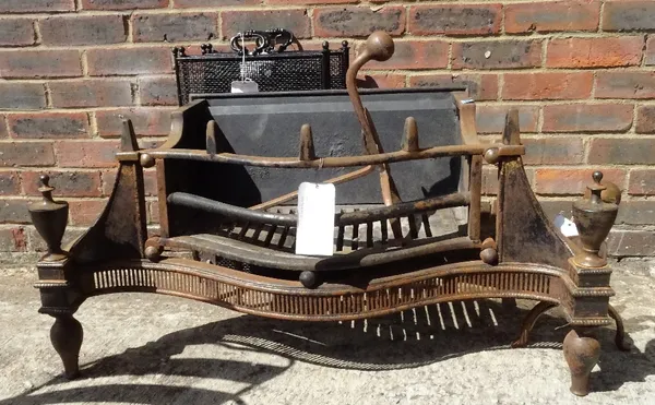 An Empire style bowfront fire grate with steel urn finials, 101cm wide, a pair of Arts & Crafts style andirons, a Victorian cast iron fire basket, two