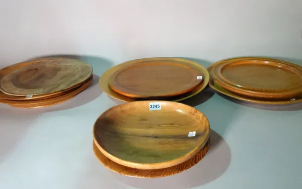 A group of nine wooden fruit plates, the largest 45cm wide.