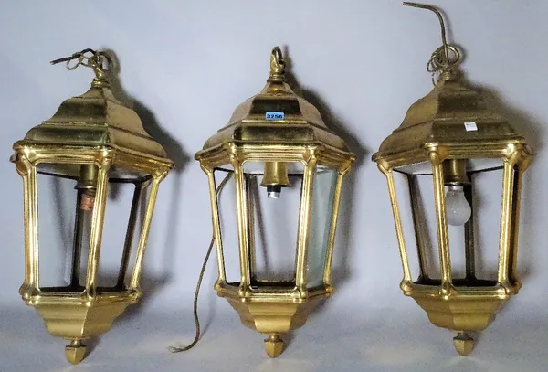 A group of three modern brass octagonal hall lanterns, 60cm high.