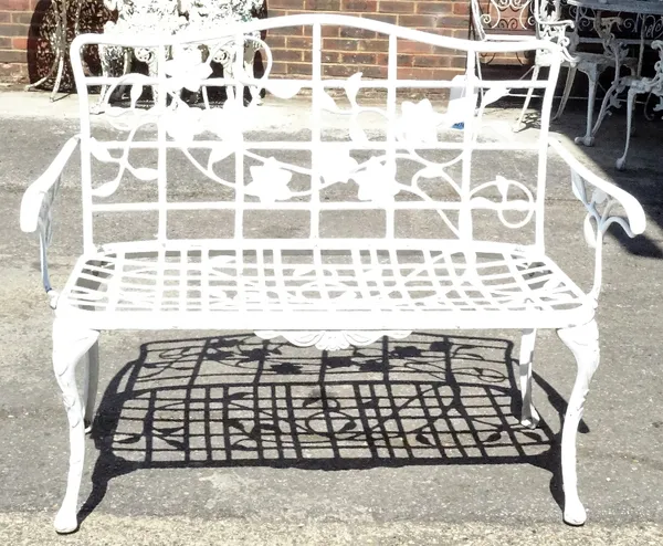 A modern white painted metal garden bench, 115cm wide x 92cm high.