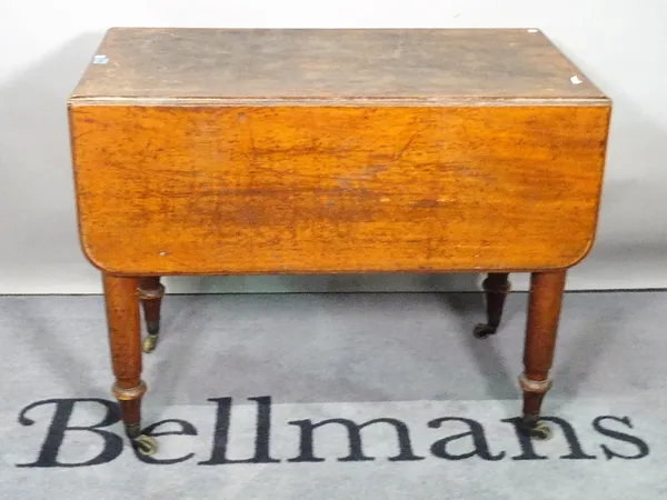 An early Victorian mahogany drop flap side table on turned supports, 90cm wide x 73cm high.