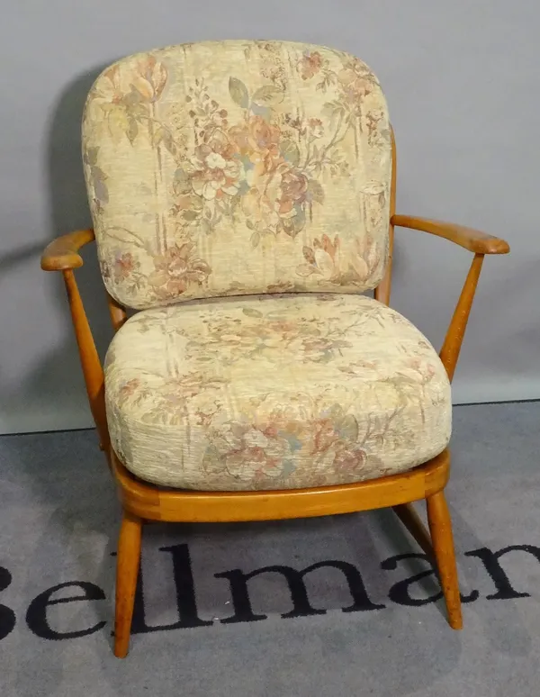 Ercol, a mid-20th century beech low open armchair, 68cm wide x 76cm high.