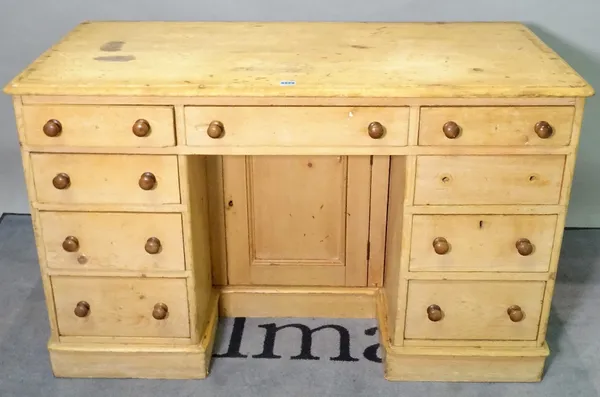 An early 20th century pine kneehole desk, with nine drawers about the knee on a plinth base, 120cm wide x 75cm high.