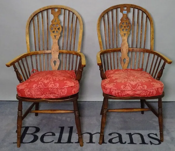 A pair of 19th century ash and elm wheelback Windsor chairs, 57cm wide x 109cm high. (2)