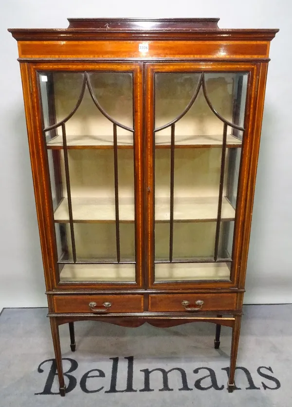 An Edwardian mahogany display cabinet, with two short drawers on tapering square supports, 90cm wide x 171cm high.