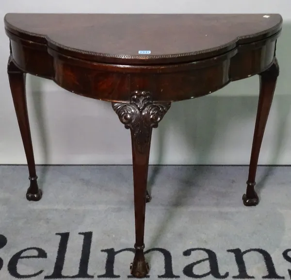 A George III style mahogany bowfront foldover card table, on acanthus turned supports, 91cm wide x 75cm high.