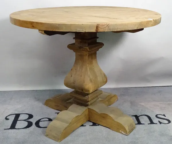 A modern pine circular dining table, on tapering column and x-frame base, 100cm diameter x 81cm high.