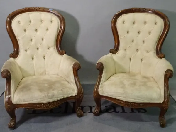 A pair of Victorian style stained beech low armchairs, with button back upholstery, 73cm wide x 104cm high. (2)