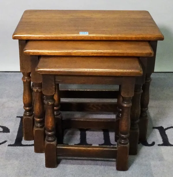 A modern oak nest of three tables, the largest 55cm wide x 47cm high.