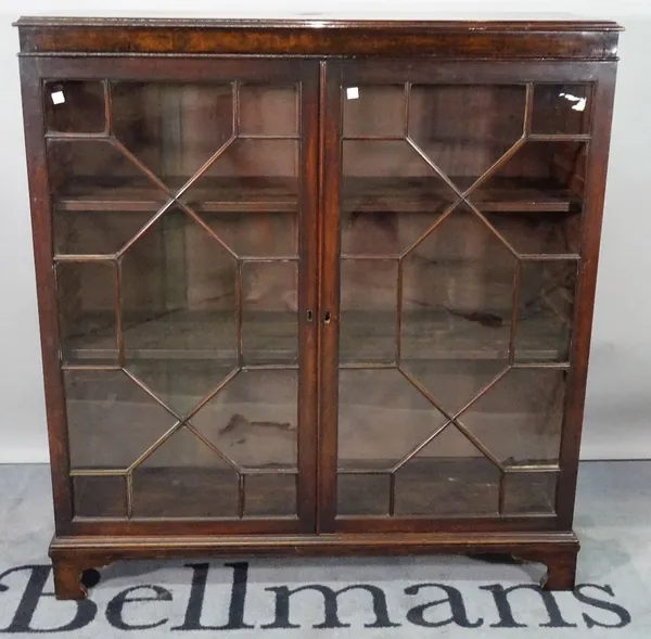 A Regency style mahogany display cabinet, with astragal glazed doors on bracket feet, 104cm wide x 113cm high.