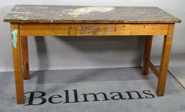 An early 20th century stained beech work table, with painted top on block supports, 149cm wide x 80cm high.