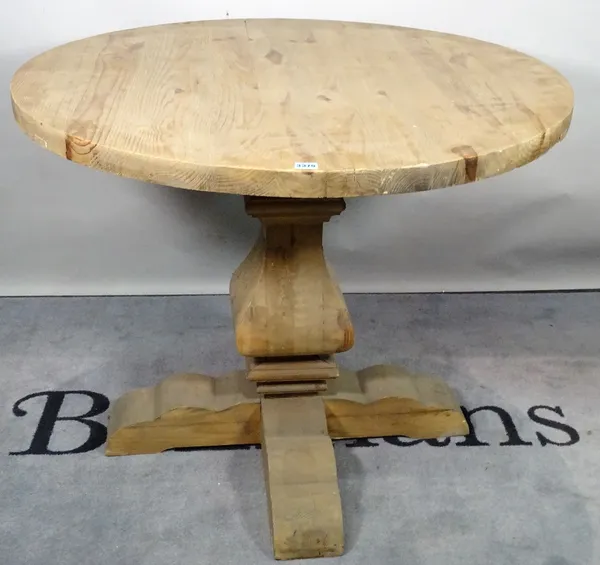 A modern pine circular dining table, on tapering column and X-frame base, 100cm diameter x 81cm high.