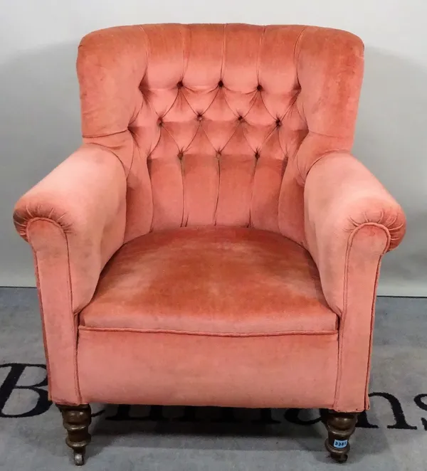 A late Victorian mahogany framed tub back armchair, with pink button back upholstery on turned supports, 78cm wide x 92cm high.