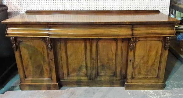 A late Victorian mahogany sideboard, with three frieze drawers over four moulded panel doors on a plinth base, 183cm wide x 92cm high.